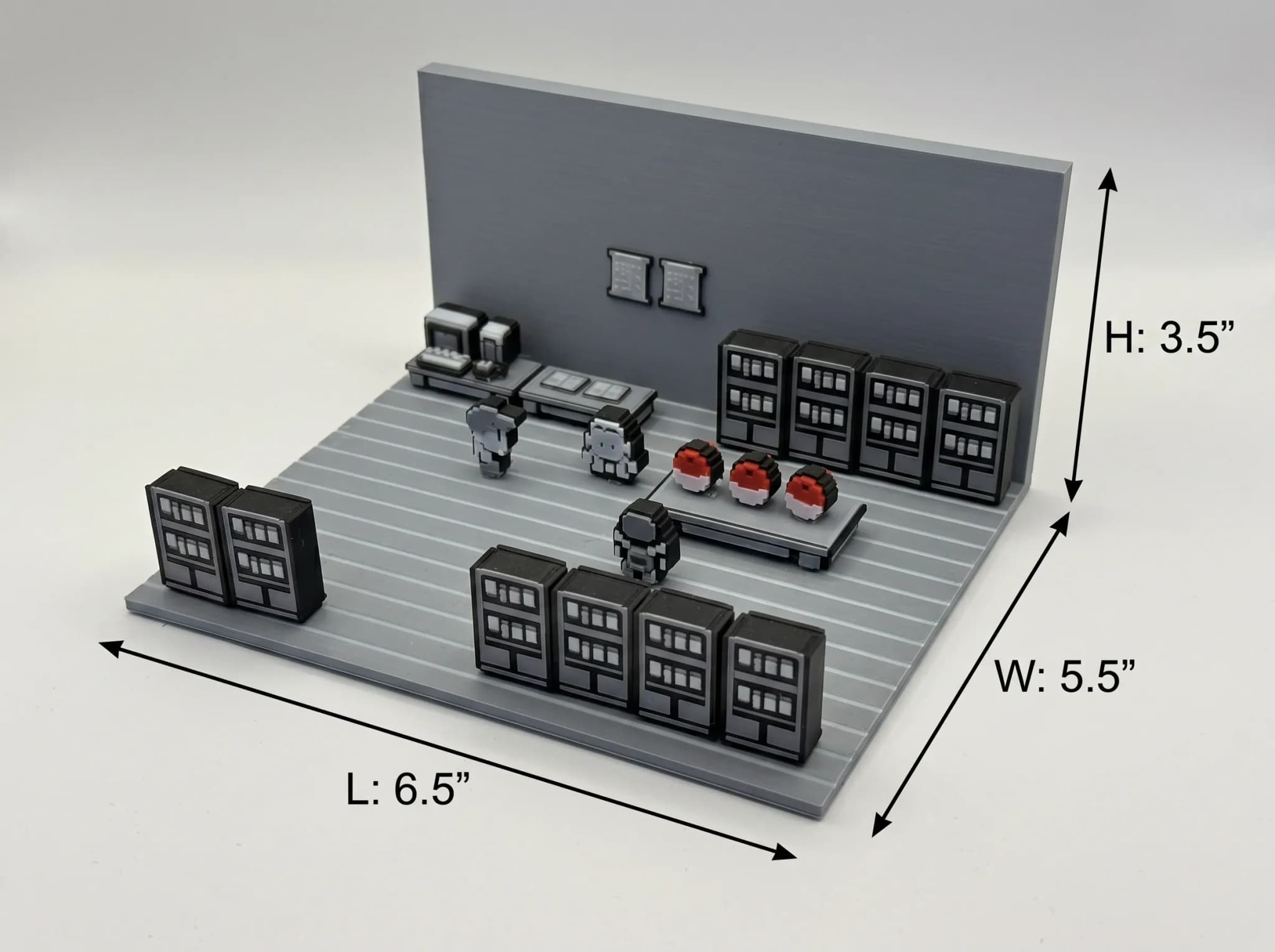 A miniature scene features two pixelated characters standing in a room with gray walls, a table displaying three red and white spherical objects, and several black storage units along the sides.